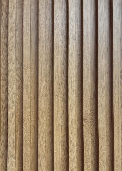Wood composite slat sample, golden oak in tone.